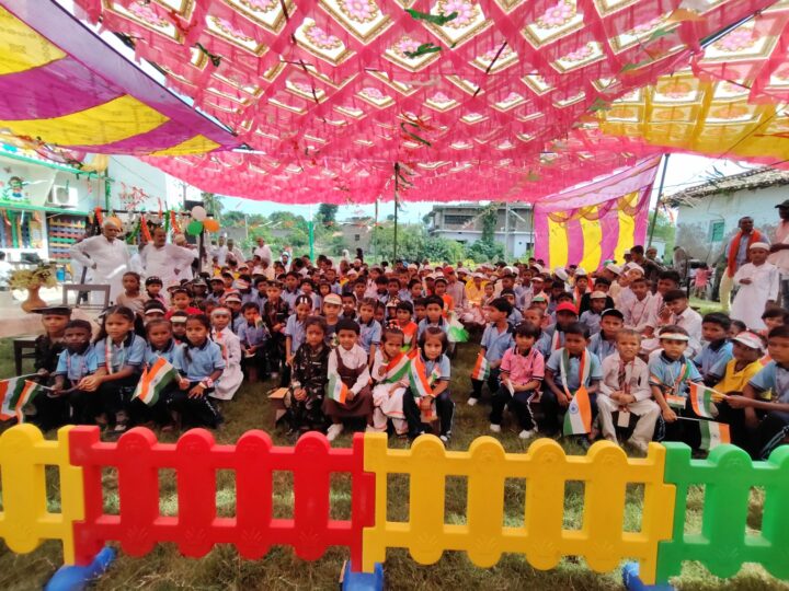 Students and families watching the Independence Day programme under the tent