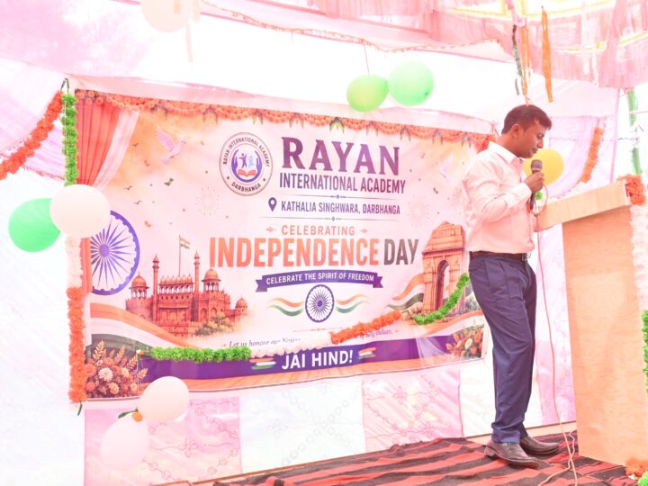 Speech on stage in front of the Independence Day banner
