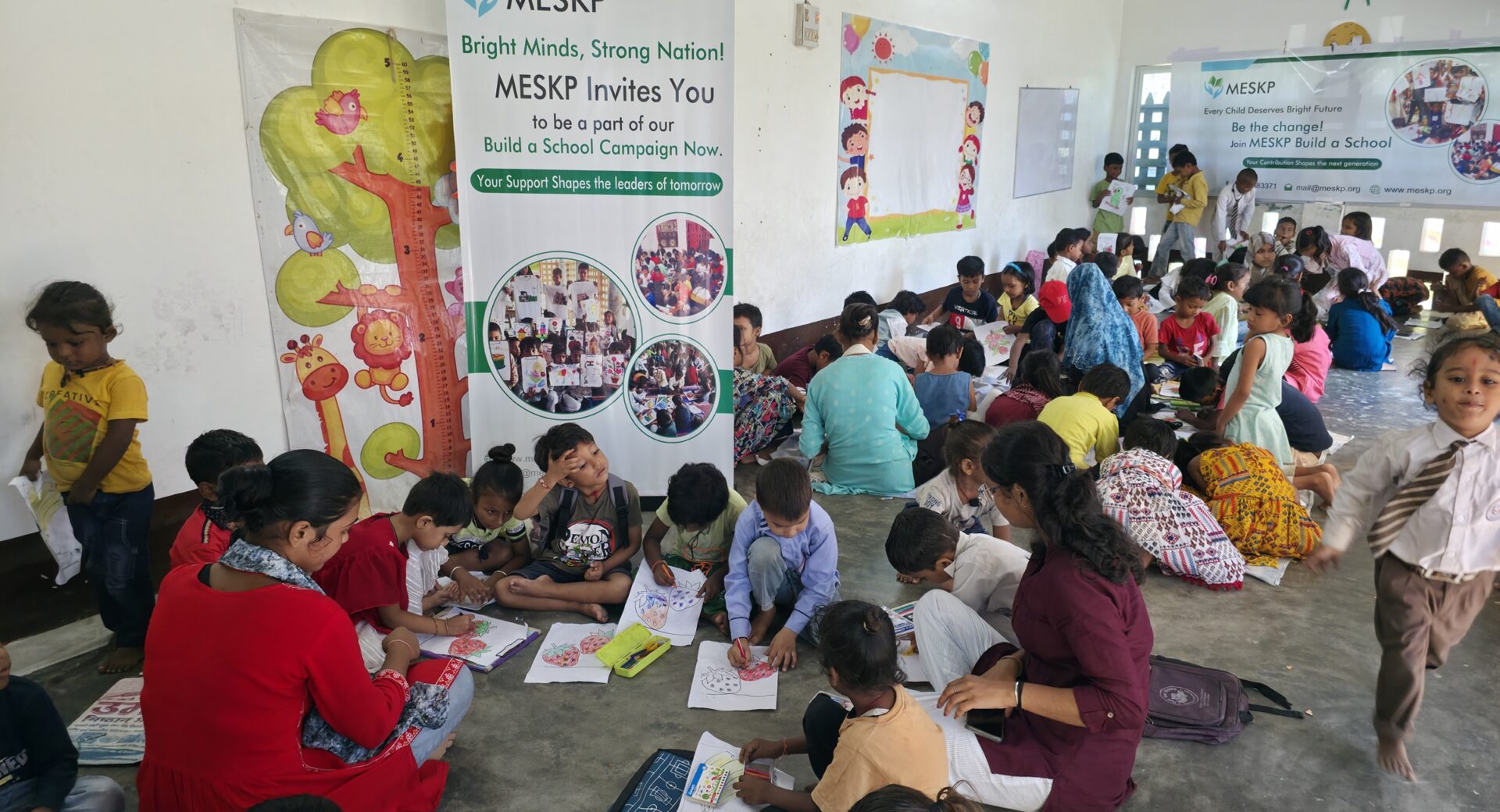 Children drawing at the Build a School campaign day, Kathalia campus