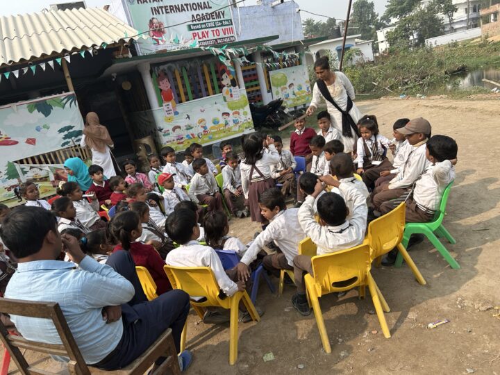 Students seated outdoors at a campus gathering