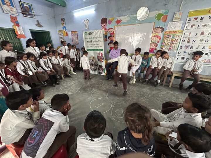 Students playing a circle game in class