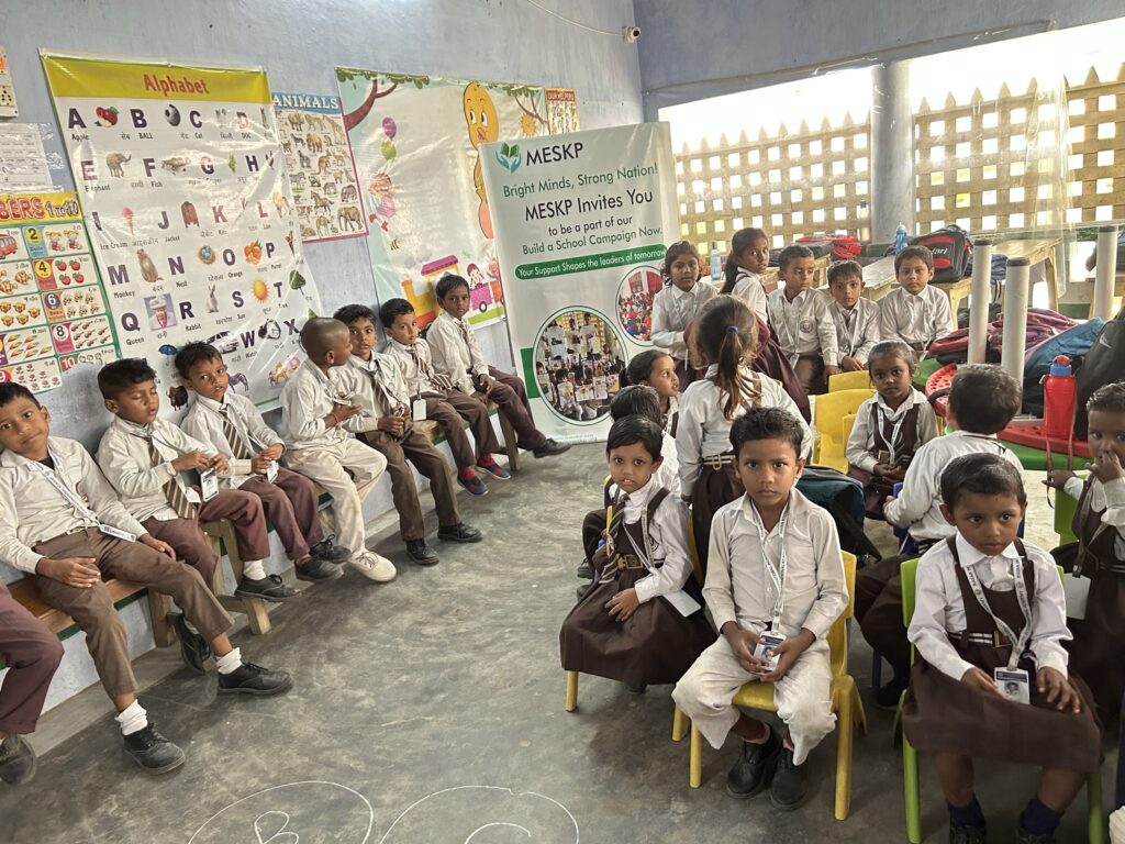 Home 8 Uniformed pre-primary class seated in a circle at the Kathalia campus