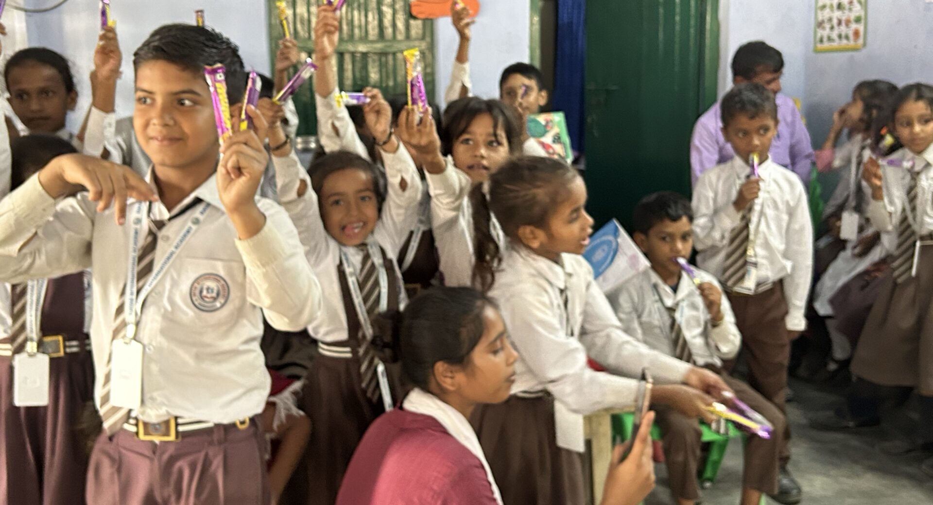 Students raising their prizes in class