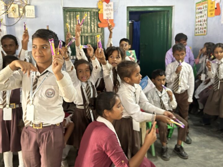 Students raising their prizes in class
