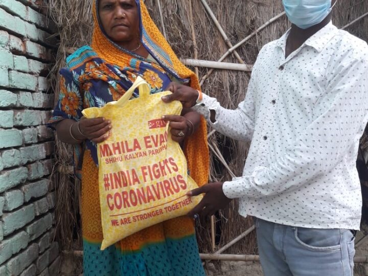 MESKP volunteer handing a relief kit to a family during COVID-19