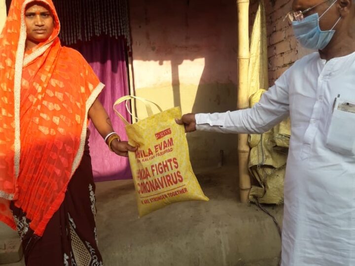 MESKP volunteer handing a relief kit to a family during COVID-19