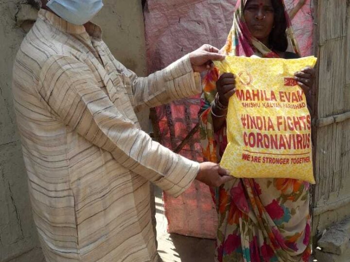 MESKP volunteer handing a relief kit to a family during COVID-19