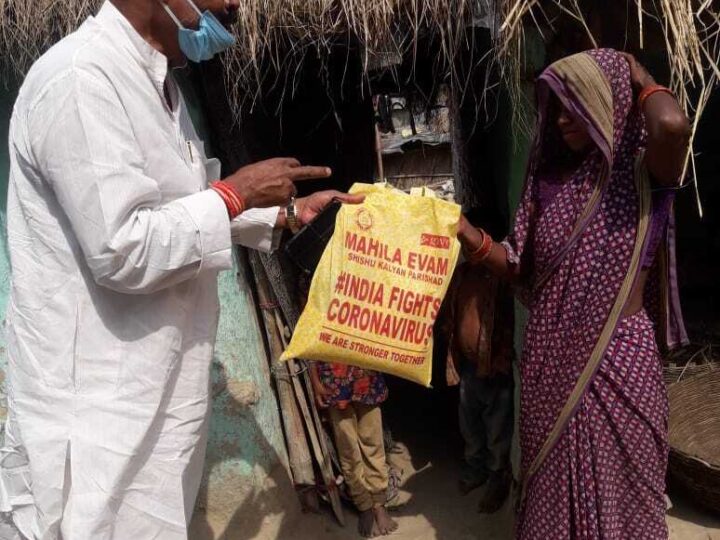 MESKP volunteer handing a relief kit to a family during COVID-19