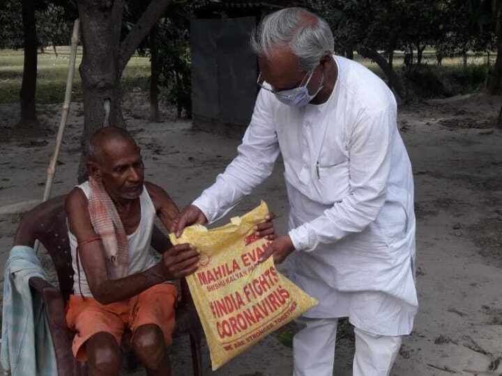 MESKP volunteer handing a relief kit to a family during COVID-19
