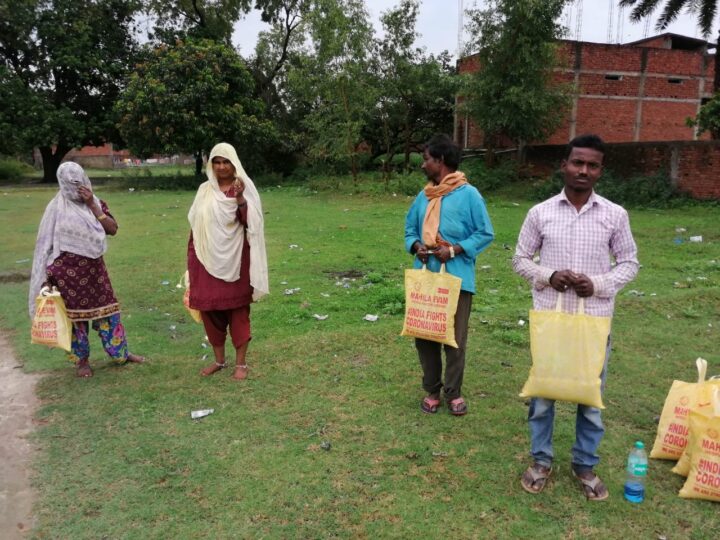 Volunteers distributing relief kits to families with social distancing during the COVID-19 lockdown