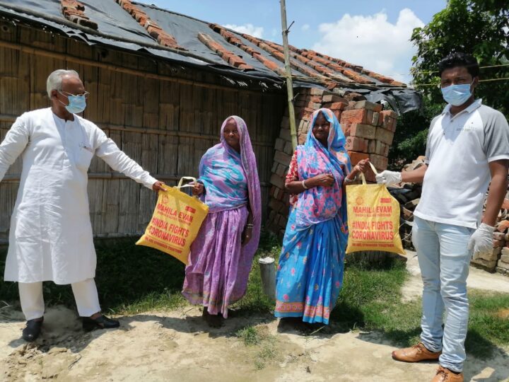 Volunteers distributing relief kits to families with social distancing during the COVID-19 lockdown