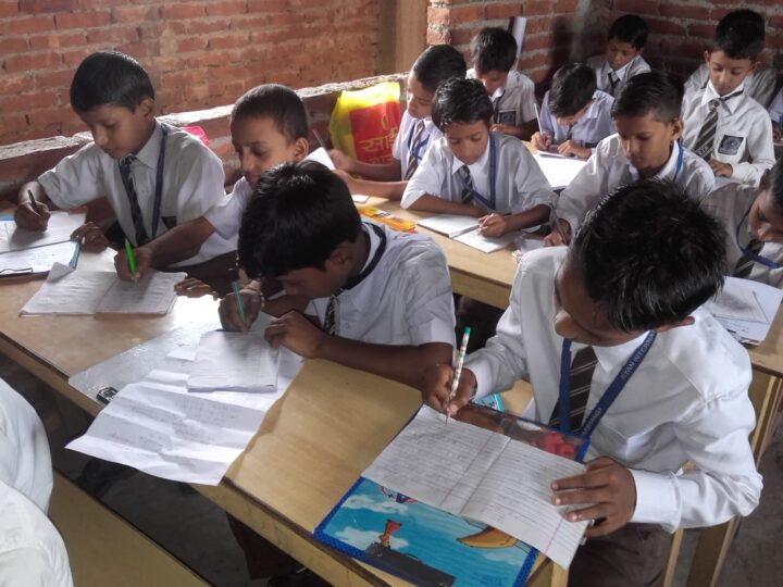 Boys writing an exam at their desks