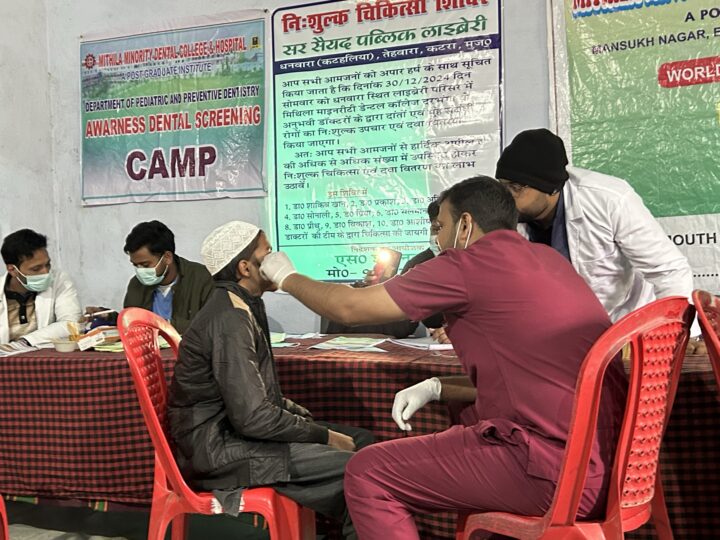 Doctor examining an elderly villager at the dental camp