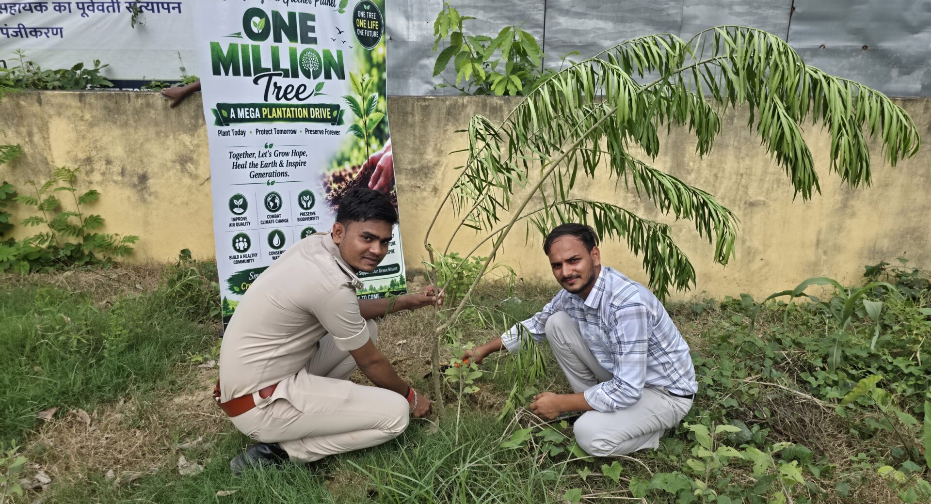 Rural Development 1 An officer and a volunteer plant a sapling in open ground