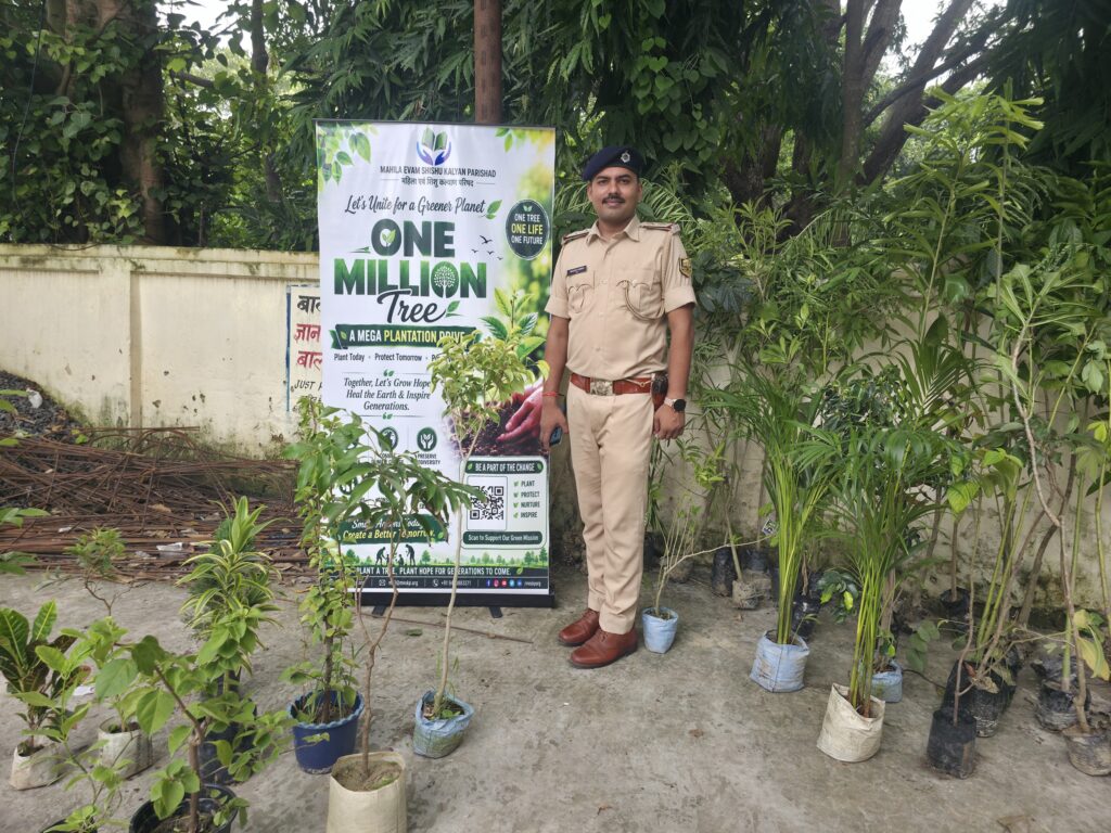 50 fruit and shade trees planted at Singhwara police station 2 A police officer beside saplings and the One Million Trees banner