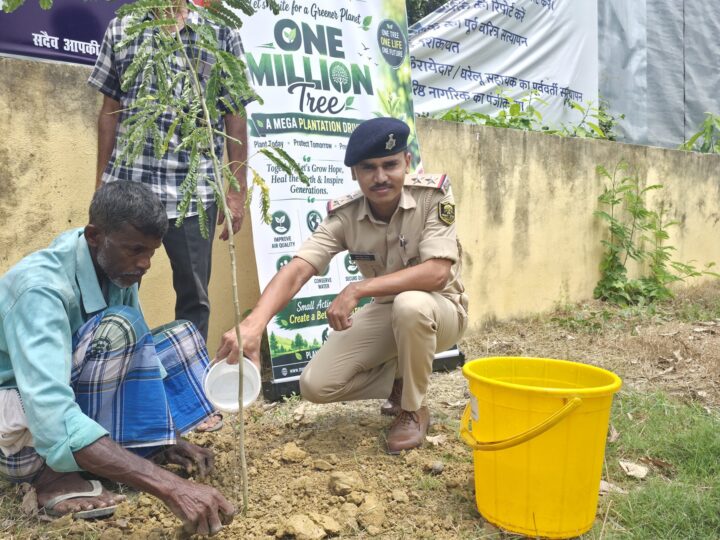 Rural Development 6 A villager waters a newly planted sapling as an officer looks on