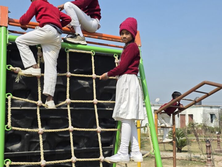 Children climbing a rope net at the playground